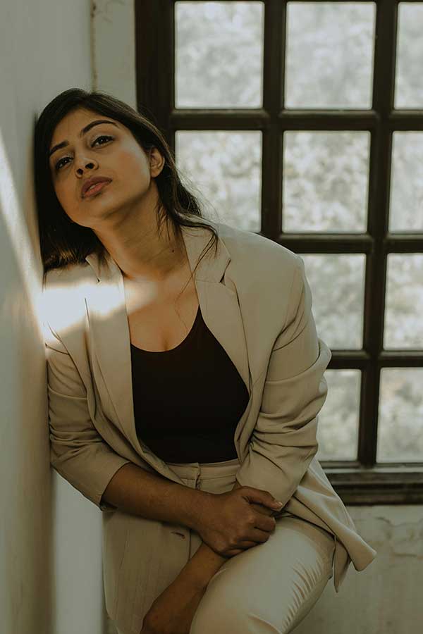 Stressed Working Mother Seeking Mindset Coaching A modern young woman feeling stressed and overwhelmed, struggling to balance work and family life.